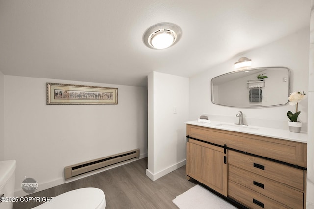 900 W Selina Ln, Wasilla, AK 99654 - half bath featuring baseboard heating, vanity, and wood finished floors