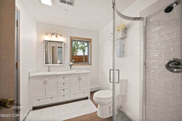 900 W Selina Ln, Wasilla, AK 99654 - bathroom featuring a stall shower, double vanity, and wood finished floors