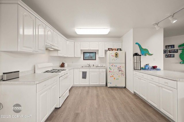 900 W Selina Ln, Wasilla, AK 99654 - kitchen featuring white appliances, light wood-style flooring, white cabinets, track lighting, and under cabinet range hood