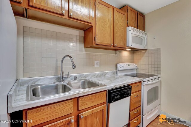 2210 Sentry Dr # B-18, Anchorage, AK 99507 - kitchen featuring white appliances, decorative backsplash, light countertops, and brown cabinetry
