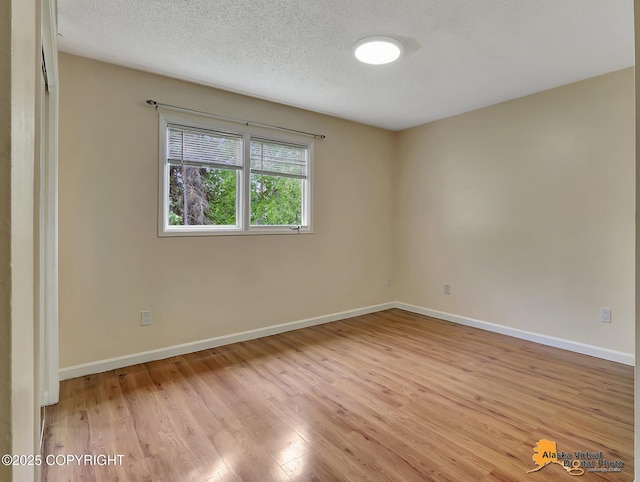 2210 Sentry Dr # B-18, Anchorage, AK 99507 - unfurnished room featuring light wood-style floors and baseboards