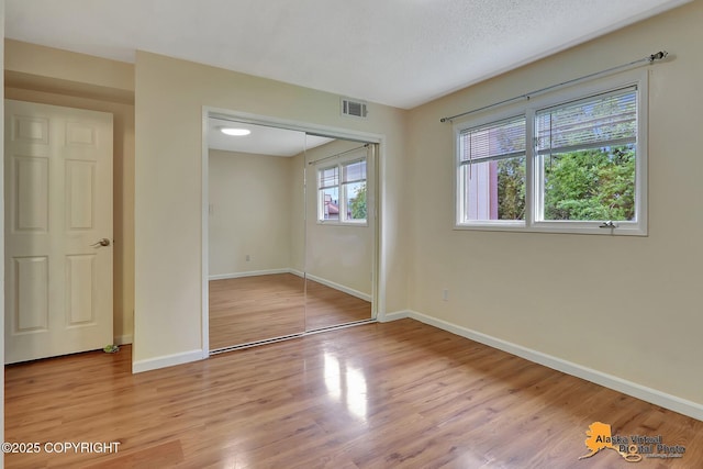 2210 Sentry Dr # B-18, Anchorage, AK 99507 - unfurnished bedroom featuring light wood-style floors and a closet