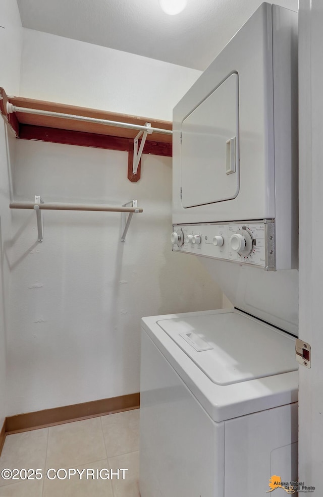 2210 Sentry Dr # B-18, Anchorage, AK 99507 - washroom with stacked washer / dryer and light tile patterned floors