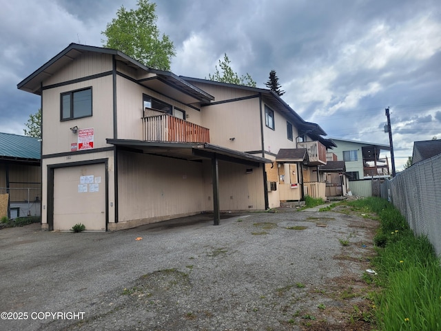 3802 Peterkin Ave, Anchorage, AK 99508 - rear view of house with a garage and a balcony