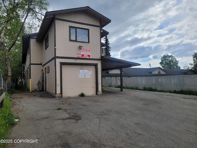 3802 Peterkin Ave, Anchorage, AK 99508 - exterior space with a garage, driveway, and a carport