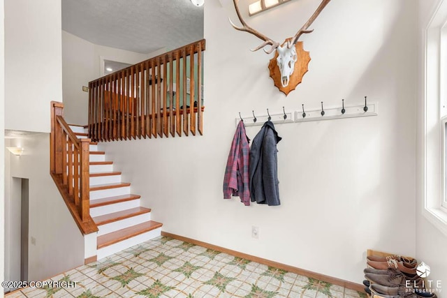 17311 Bonasila Cir, Eagle River, AK 99577 - staircase with tile patterned floors and a textured ceiling