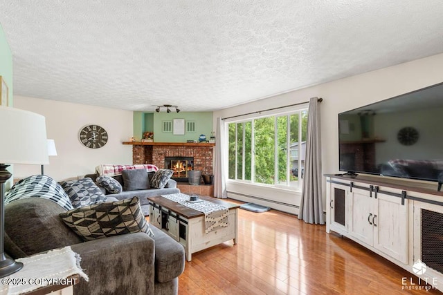 17311 Bonasila Cir, Eagle River, AK 99577 - living area with baseboard heating, hardwood / wood-style flooring, a fireplace, and a textured ceiling