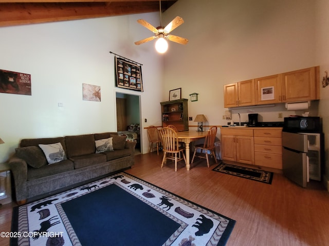 13925 Ravenquest Ave, Seward, AK 99664 - living area featuring high vaulted ceiling, wood finished floors, ceiling fan, and beam ceiling