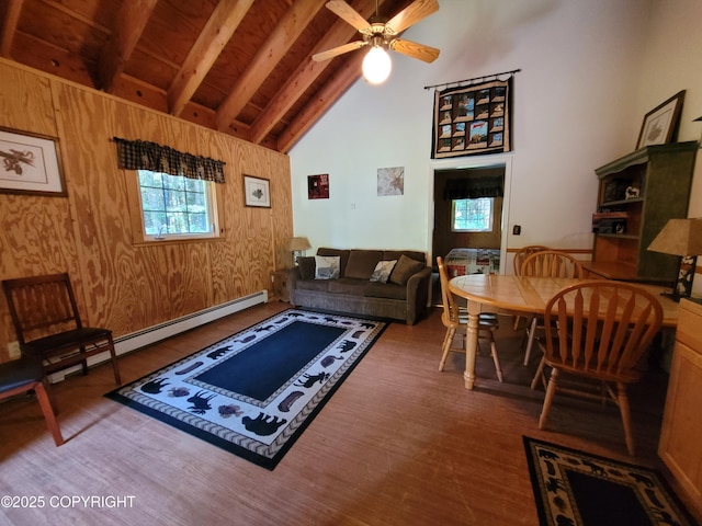 13925 Ravenquest Ave, Seward, AK 99664 - living room with wood finished floors, beam ceiling, high vaulted ceiling, a ceiling fan, and wooden walls