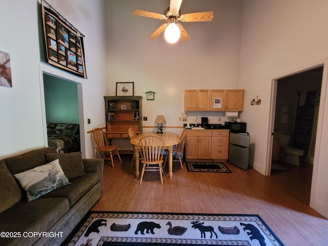 13925 Ravenquest Ave, Seward, AK 99664 - living area with wood finished floors, a high ceiling, and ceiling fan