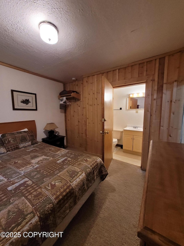 13925 Ravenquest Ave, Seward, AK 99664 - bedroom with wood walls, carpet flooring, a textured ceiling, and ensuite bath