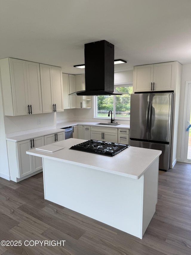 1510 Fathom Dr, Kenai, AK 99611 - kitchen featuring stainless steel appliances, a center island, wood finished floors, light countertops, and white cabinetry