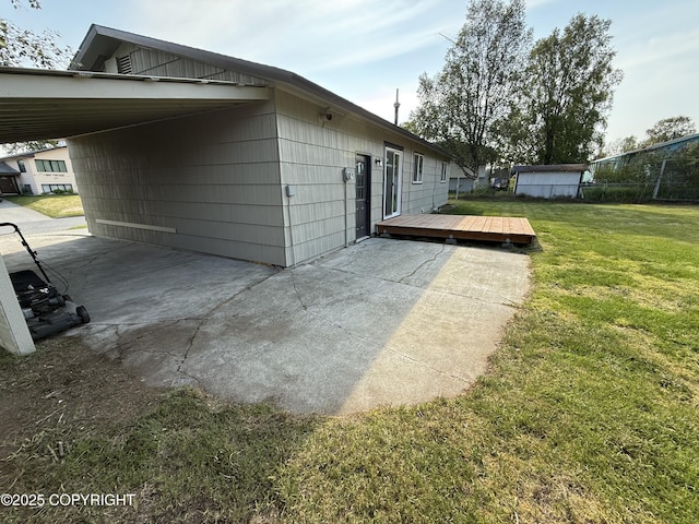 1510 Fathom Dr, Kenai, AK 99611 - view of side of home featuring a yard, a deck, and an attached carport