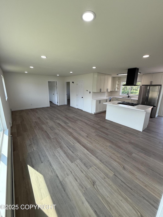 1510 Fathom Dr, Kenai, AK 99611 - kitchen with freestanding refrigerator, open floor plan, recessed lighting, light countertops, and a center island