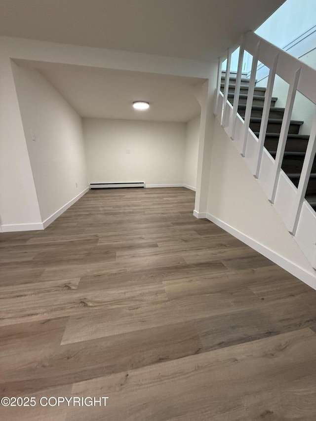 1510 Fathom Dr, Kenai, AK 99611 - basement featuring baseboard heating, stairs, and wood finished floors