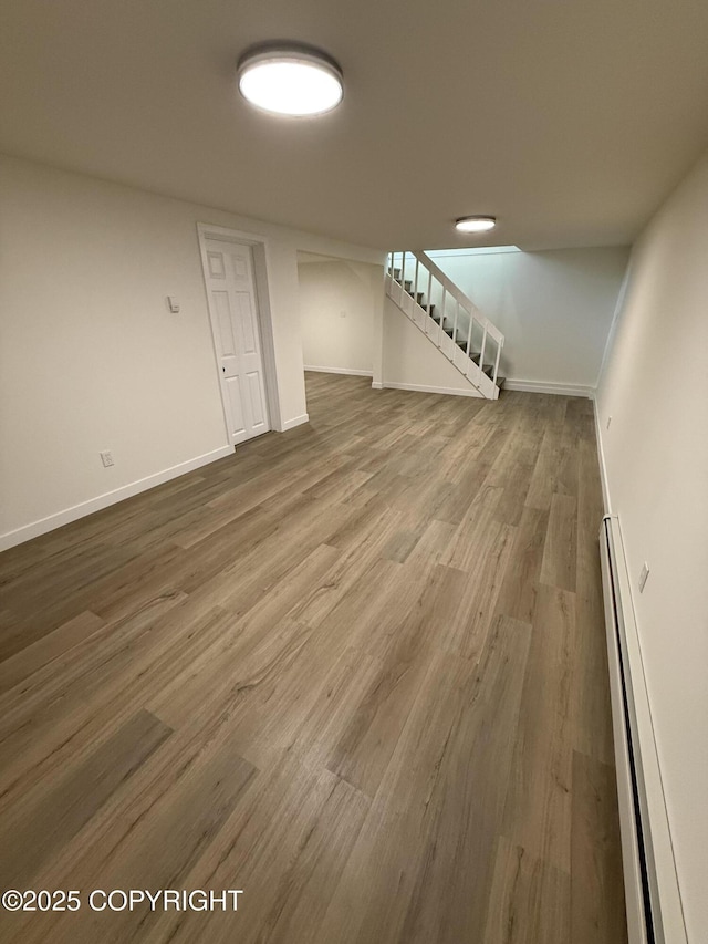 1510 Fathom Dr, Kenai, AK 99611 - unfurnished living room with baseboard heating, stairs, and wood finished floors