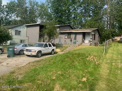 1011 Friendly Ln, Anchorage, AK 99504 - view of front facade with a front yard and driveway