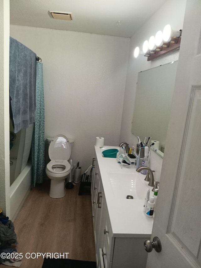 1011 Friendly Ln, Anchorage, AK 99504 - full bath with wood finished floors, vanity, and shower / bath combination with curtain
