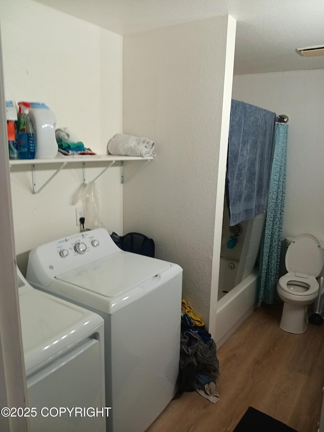 1011 Friendly Ln, Anchorage, AK 99504 - laundry area with washer and clothes dryer and wood finished floors