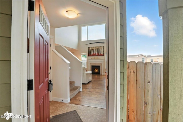 339 Skwentna Dr # 24, Anchorage, AK 99504 - foyer entrance featuring stairway, a lit fireplace, and wood finished floors