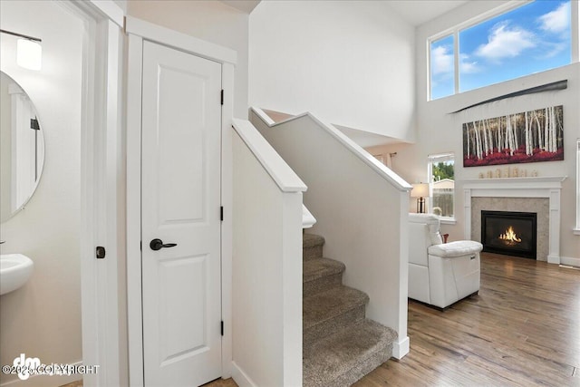 339 Skwentna Dr # 24, Anchorage, AK 99504 - stairs with wood finished floors, a glass covered fireplace, and a high ceiling