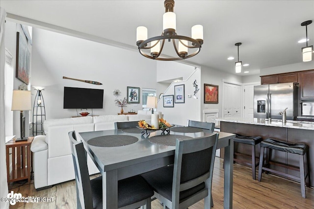 339 Skwentna Dr # 24, Anchorage, AK 99504 - dining space featuring a chandelier, light wood-style flooring, and recessed lighting