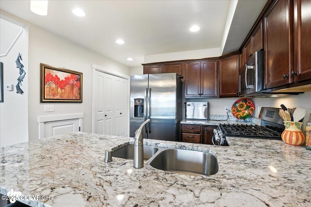 339 Skwentna Dr # 24, Anchorage, AK 99504 - kitchen featuring stainless steel appliances, light stone counters, dark brown cabinets, and recessed lighting