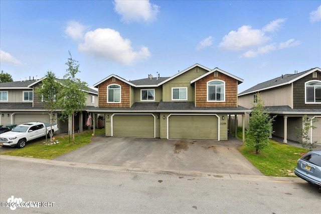339 Skwentna Dr # 24, Anchorage, AK 99504 - view of front of home with driveway, a garage, and roof with shingles