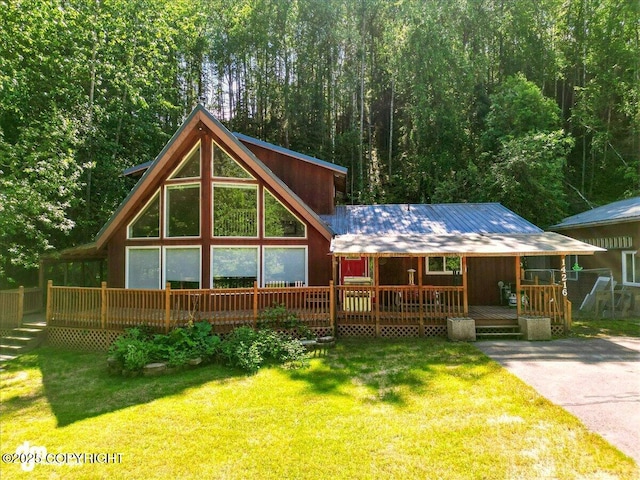 14216 W Norcross St, Big Lake, AK 99623 - rustic home featuring a front lawn, a metal roof, and a wooded view