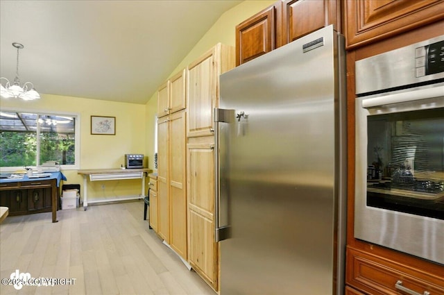 14216 W Norcross St, Big Lake, AK 99623 - kitchen featuring appliances with stainless steel finishes, vaulted ceiling, light wood-style floors, a chandelier, and decorative light fixtures