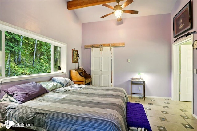 14216 W Norcross St, Big Lake, AK 99623 - tiled bedroom with a barn door, beamed ceiling, ceiling fan, and high vaulted ceiling