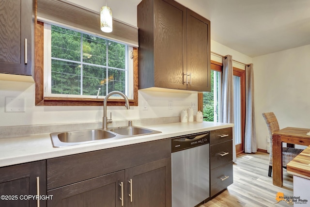6312 Air Guard Rd, Anchorage, AK 99502 - kitchen featuring stainless steel dishwasher, light countertops, light wood-style flooring, and dark brown cabinetry