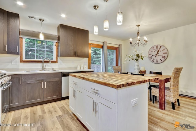 6312 Air Guard Rd, Anchorage, AK 99502 - kitchen with butcher block countertops, stainless steel appliances, light wood-style floors, and decorative light fixtures