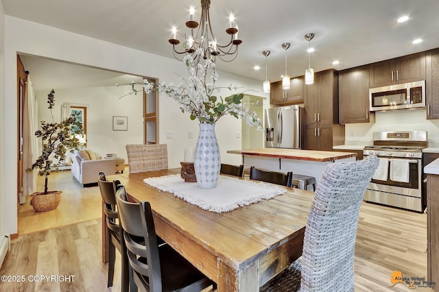 6312 Air Guard Rd, Anchorage, AK 99502 - dining area featuring light wood-style floors, recessed lighting, a chandelier, and baseboard heating
