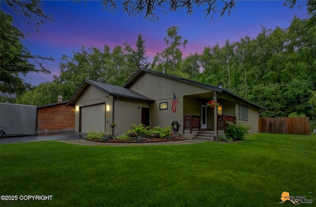 6312 Air Guard Rd, Anchorage, AK 99502 - ranch-style home with concrete driveway, an attached garage, and a porch