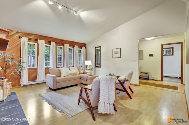 6312 Air Guard Rd, Anchorage, AK 99502 - living area featuring track lighting, light wood-type flooring, baseboard heating, and high vaulted ceiling