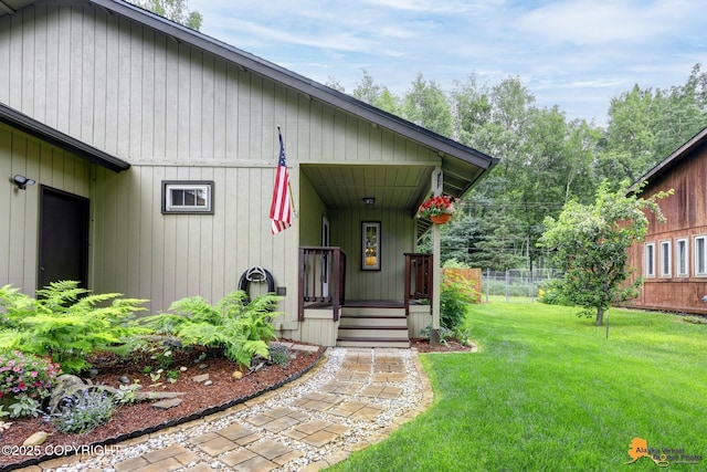 6312 Air Guard Rd, Anchorage, AK 99502 - property entrance featuring covered porch and a lawn