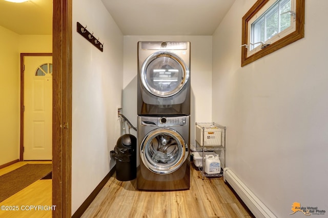 6312 Air Guard Rd, Anchorage, AK 99502 - laundry room with stacked washing machine and dryer, light wood-style floors, and a baseboard radiator