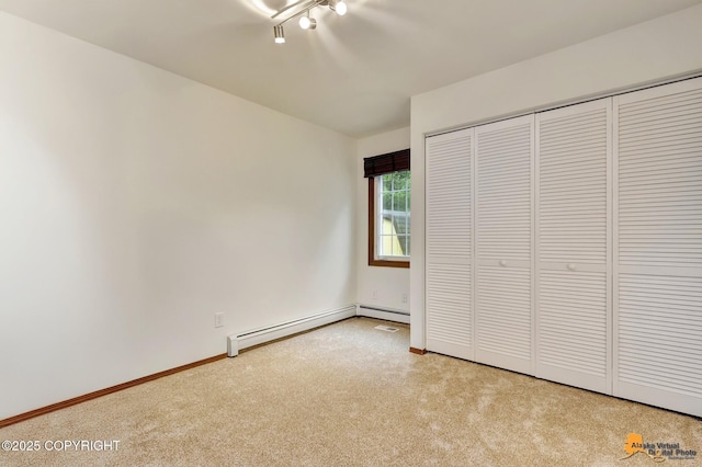 6312 Air Guard Rd, Anchorage, AK 99502 - unfurnished bedroom featuring baseboard heating, light colored carpet, and a closet
