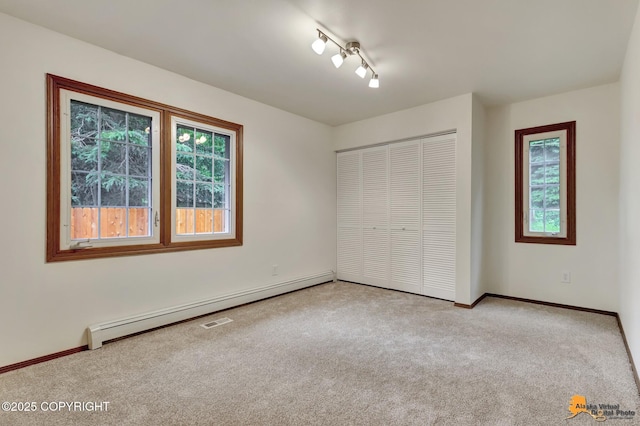 6312 Air Guard Rd, Anchorage, AK 99502 - unfurnished bedroom with baseboard heating, carpet, and a closet