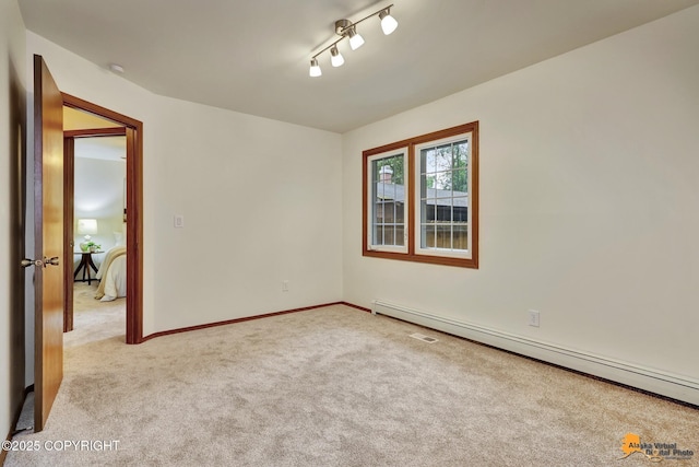 6312 Air Guard Rd, Anchorage, AK 99502 - unfurnished room with baseboard heating and light colored carpet