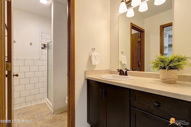 6312 Air Guard Rd, Anchorage, AK 99502 - bathroom featuring a shower stall, vanity, tile patterned floors, and tile walls