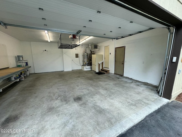 6312 Air Guard Rd, Anchorage, AK 99502 - garage featuring water heater, a garage door opener, and freestanding refrigerator