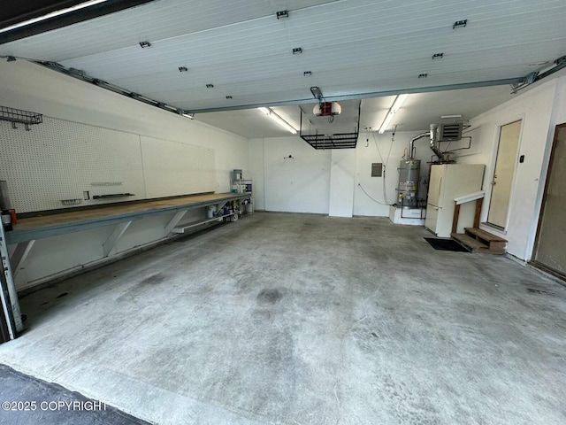 6312 Air Guard Rd, Anchorage, AK 99502 - garage featuring water heater, a garage door opener, and freestanding refrigerator
