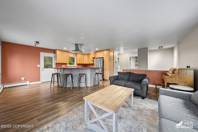 1740 Patterson Ct, Anchorage, AK 99504 - living area featuring a baseboard radiator, light wood finished floors, and recessed lighting