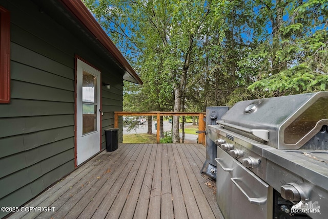 1740 Patterson Ct, Anchorage, AK 99504 - wooden terrace featuring grilling area and view of wooded area