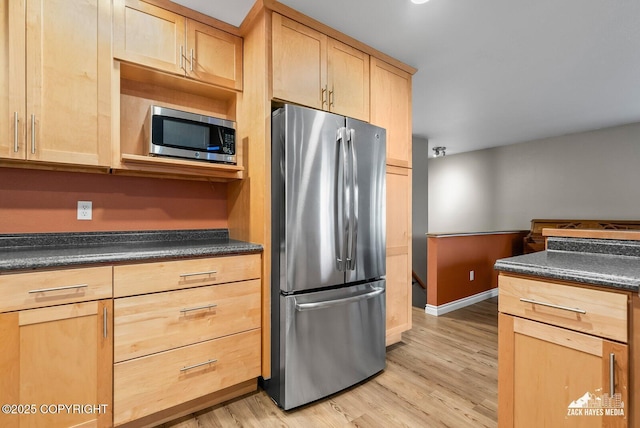1740 Patterson Ct, Anchorage, AK 99504 - kitchen with appliances with stainless steel finishes, light brown cabinets, dark countertops, and light wood finished floors