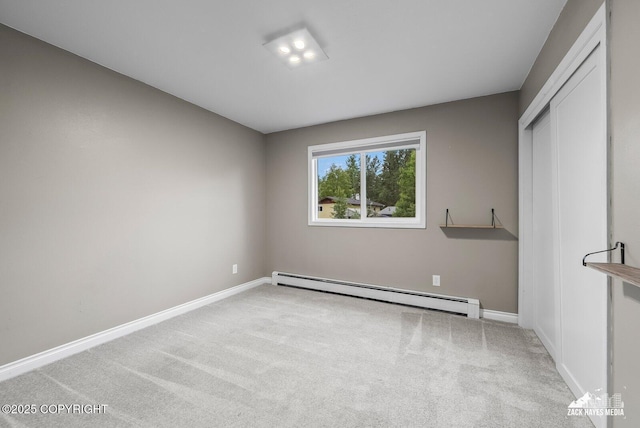 1740 Patterson Ct, Anchorage, AK 99504 - unfurnished bedroom with a baseboard heating unit and light colored carpet