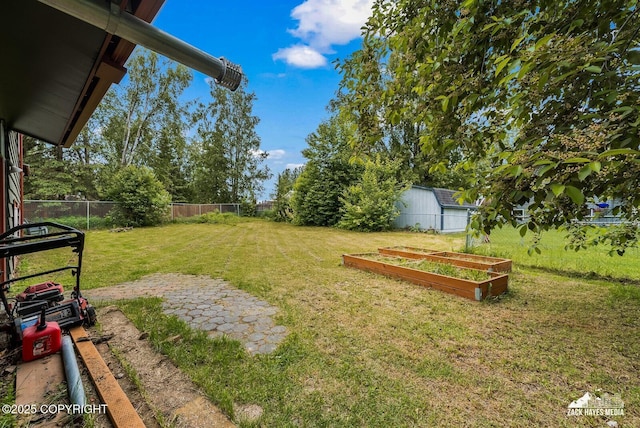 1740 Patterson Ct, Anchorage, AK 99504 - fenced backyard featuring a vegetable garden