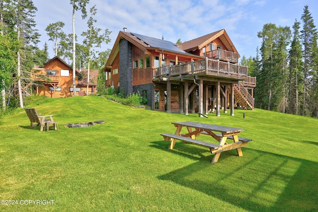 37905 Hall Rd, Sterling, AK 99672 - rear view of house featuring a wooden deck, a lawn, and stairs